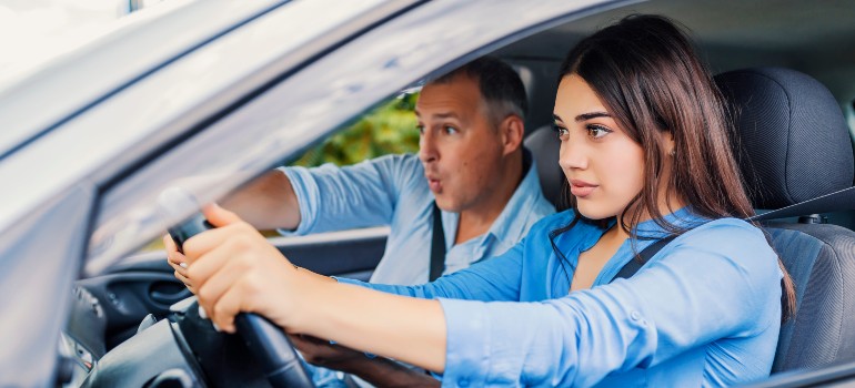 Man pointing in car